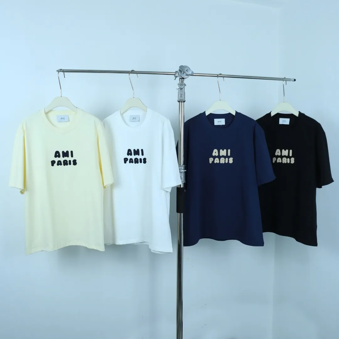 Style No.: A 008# P57 Ami 2026 Spring/Summer New Arrival T-shirt Short Sleeve The workmanship of this chapter is extremely cumbersome and complicated. It uses water-soluble polyester and water-soluble thread, first starting the pattern, dyeing, then air-drying, shaping, and then laser processing of details. The process time is long, which distinguishes it from the garbage version of the leaky bottom fabric on the market. We completely restore the correct version of the official website 1:1, with high-weight fabrics, synchronized detail routing, and restored official website letter embroidery, which is the only correct version on the entire network. Color: Apricot Black Navy Blue White Sizes: S-XL